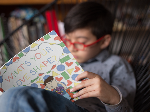 boy reads whats your love shape on a chair