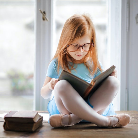 little girl reading childrens book | contact